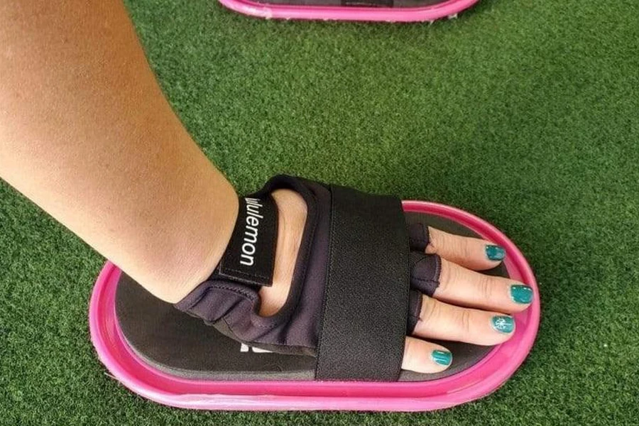 Person using core sliders with straps on a carpet