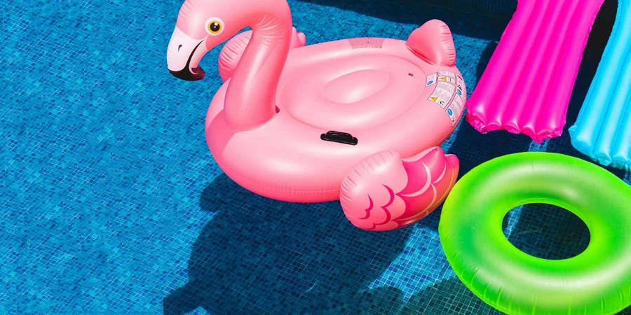 Pink Flamingo Inflatable Ring and Green Inflatable Ring on Swimming Pool