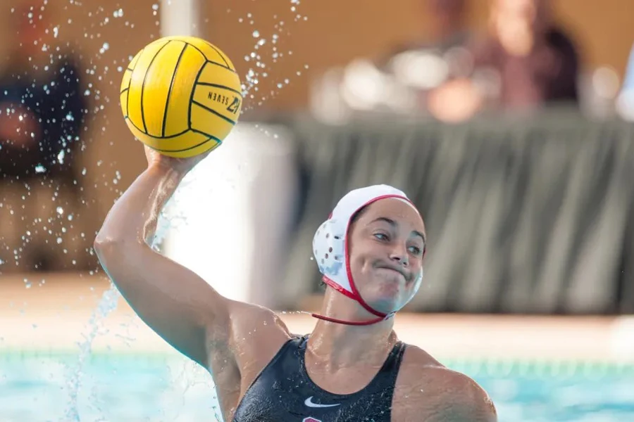 Player holding a yellow water polo ball