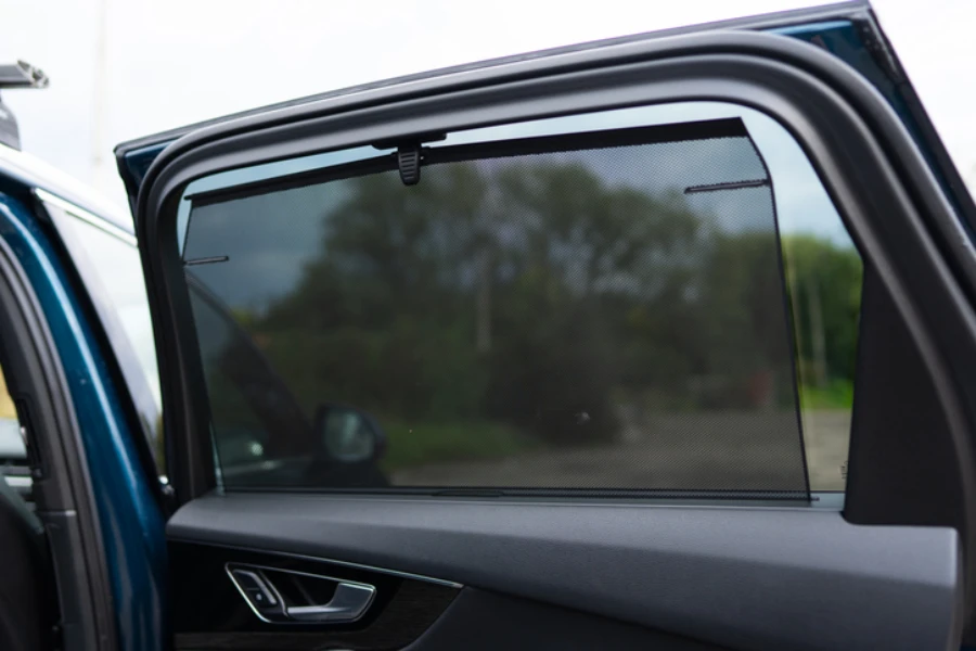 Rear window sunshade providing additional protection for back seat passengers of expensive auto.