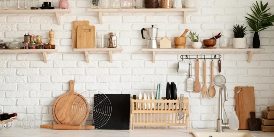 Rustic kitchen interior with white brick wall and white wooden shelves