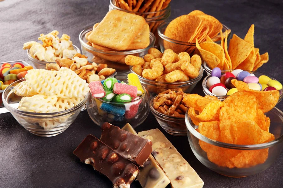 Salty snacks. Pretzels, chips, crackers in glass bowls