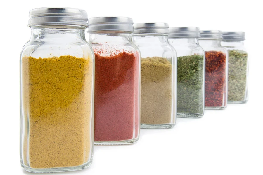 Set of assorted colorful powder spices in glass bottle isolated