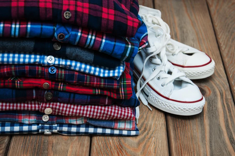 Stacks of checkered shirts and sneakers