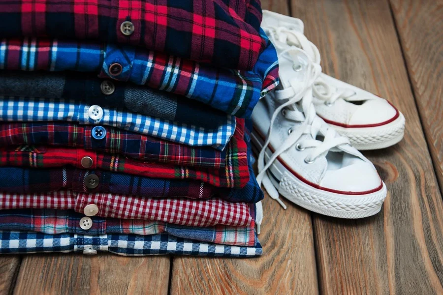 Stacks of checkered shirts and sneakers