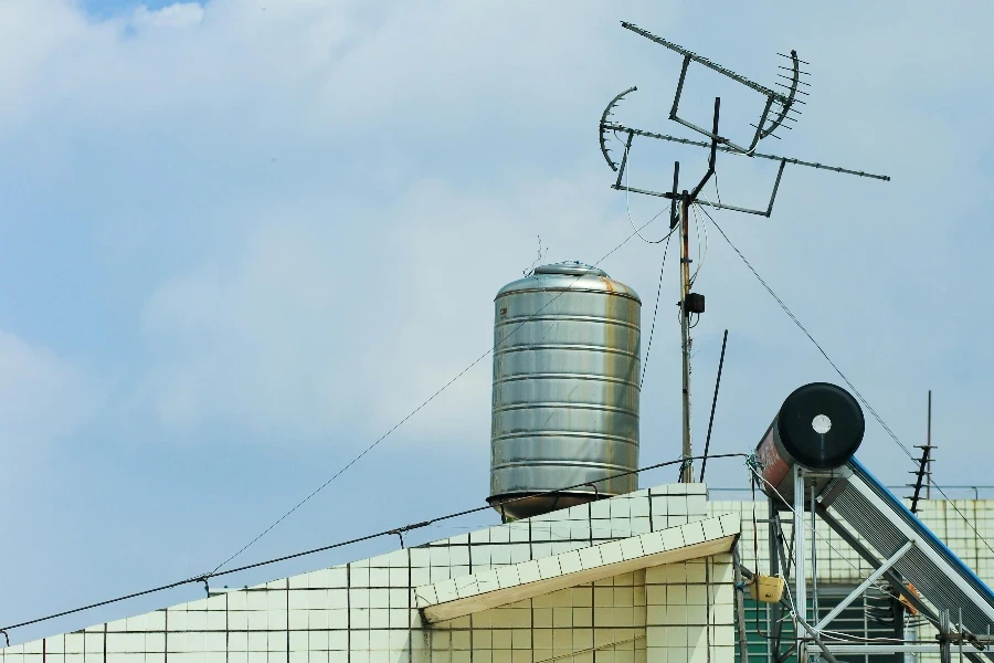 Rostfreier Wassertank auf einem Dach unter blauem Himmel