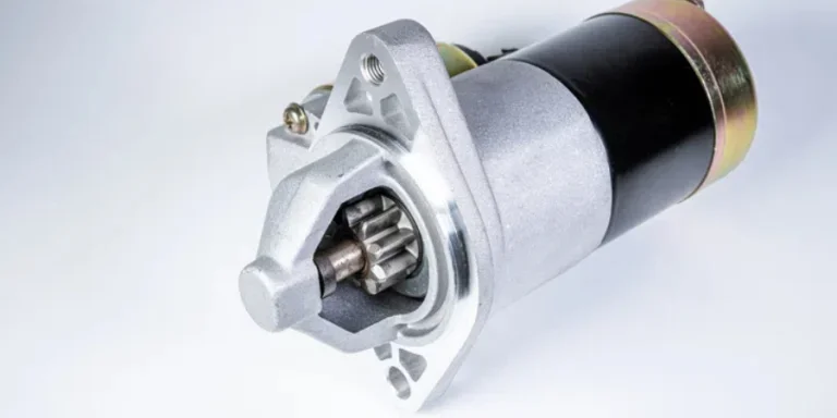 Starter of an internal combustion engine New Spare part for car on a gray background