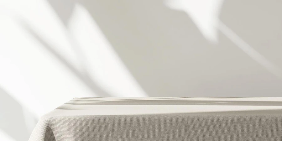 Table counter with beige brown tablecloth drape in sunlight