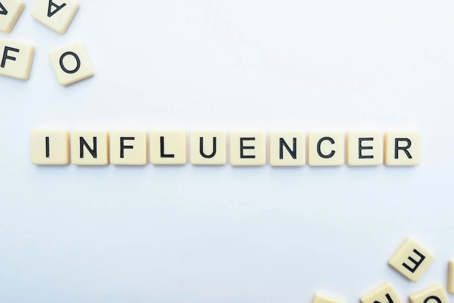 The word “INFLUENCER” spelled out in Scrabble letters