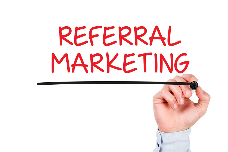 The words “REFERRAL MARKETING” on a whiteboard