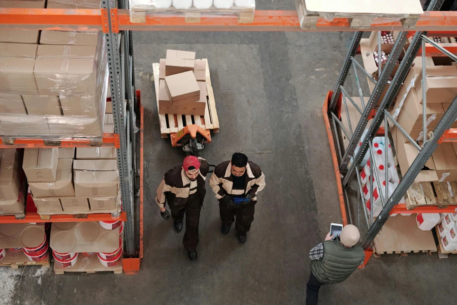 Three men working in a warehouse