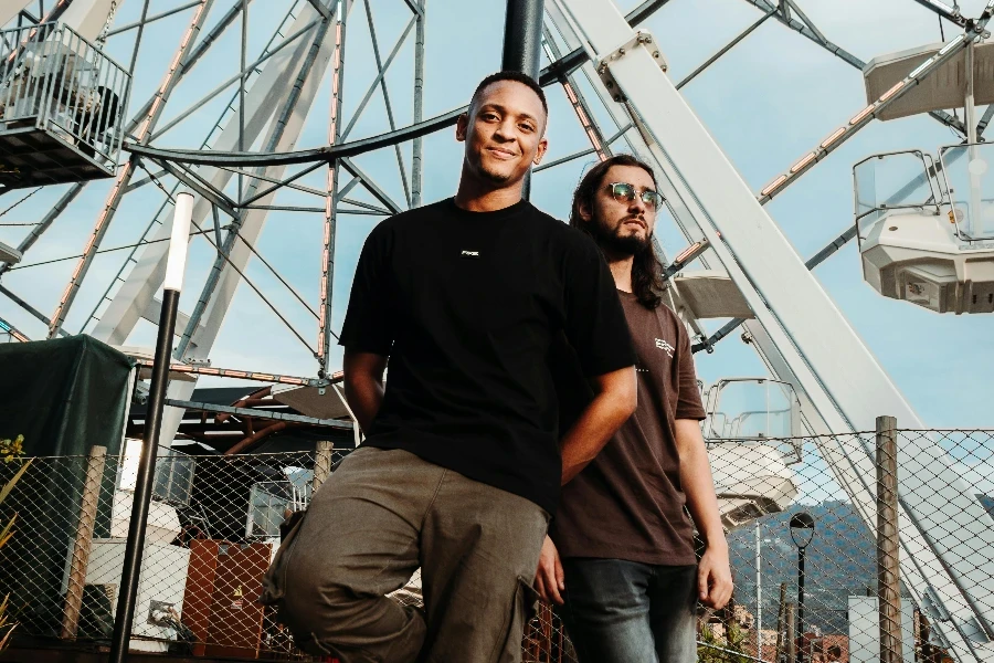 Two people standing in front of a ferris wheel