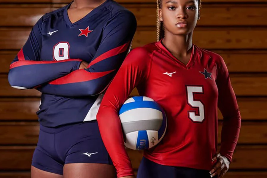 Two players posing in long sleeve volleyball jerseys