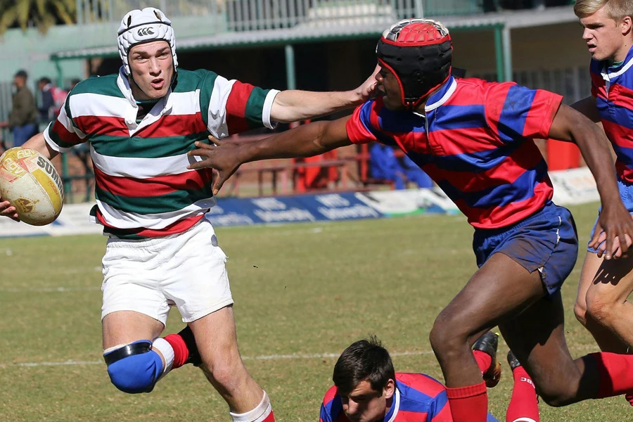 Two rugby players wearing scrum caps
