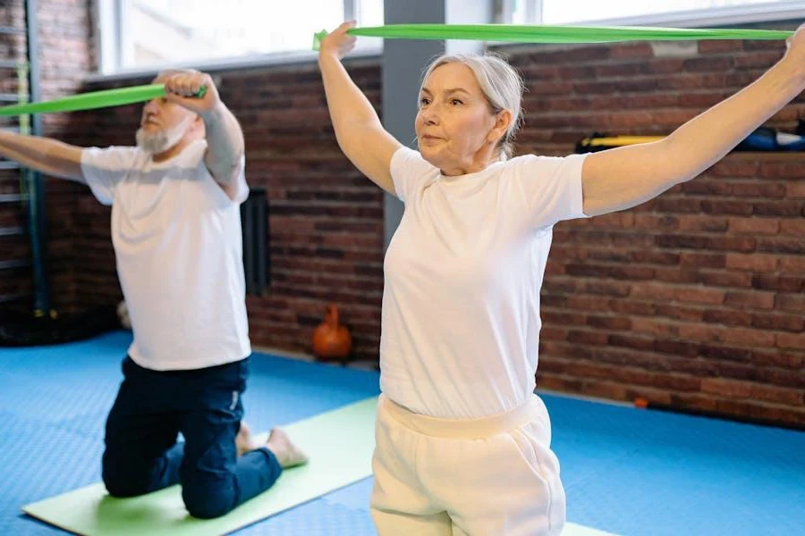 Two seniors exercising with resistance bands