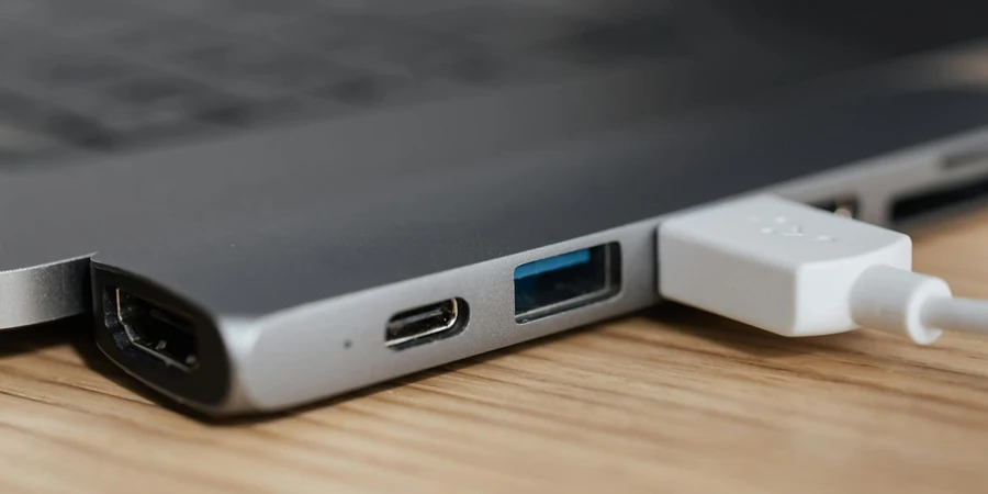 USB type c multiport adapter with plugged white cable connected to modern laptop