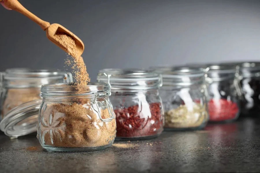 Various Oriental spices and herbs in glass jars. Selective focus