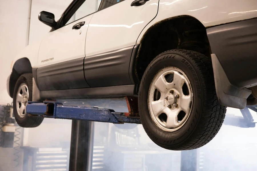 White Car Hanging on a Car Lift