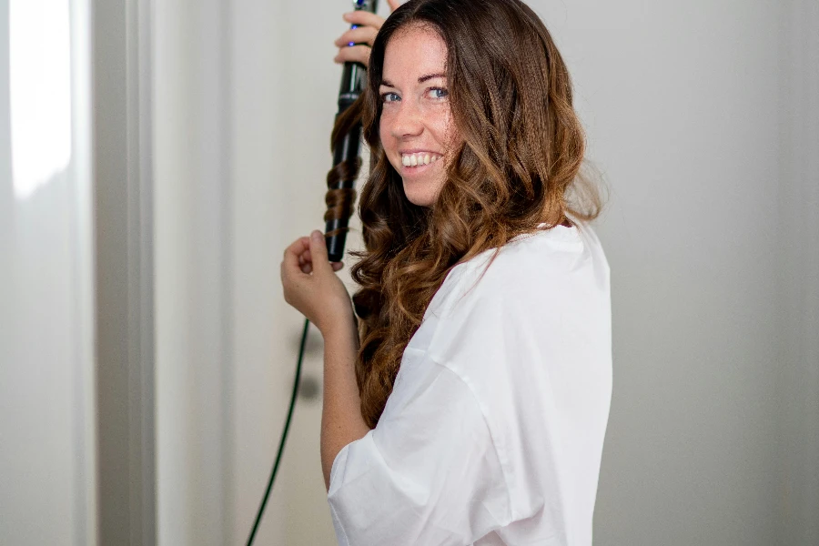 Woman Holding a Hair Curler