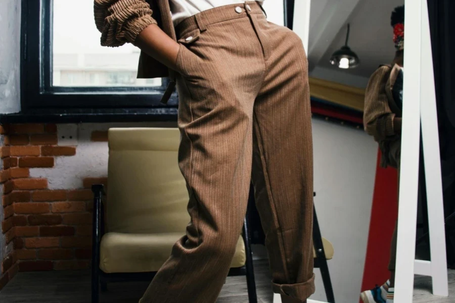 Woman Standing in Front of Mirror With Hands in Pockets