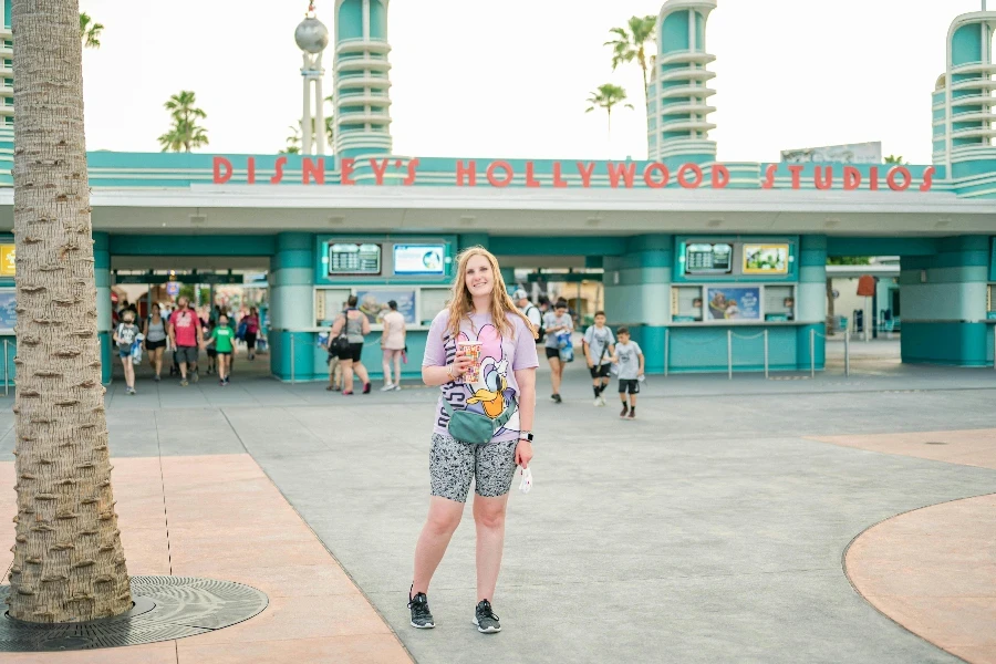 Woman Standing in Front of a Blue Building