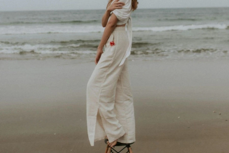 Woman Standing on Chair on Seashore