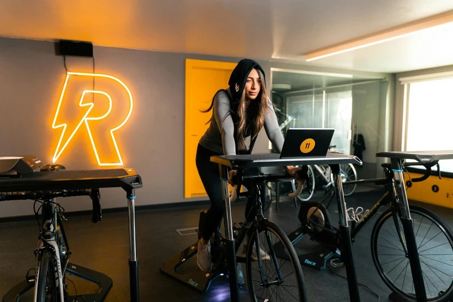 Woman Training on Stationary Bike at Gym