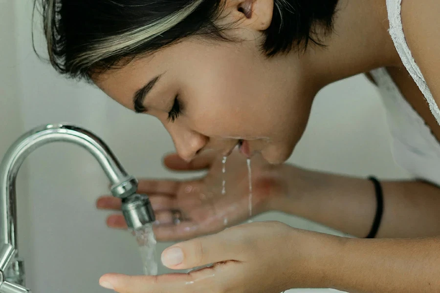 Woman Washing Her Face With Water