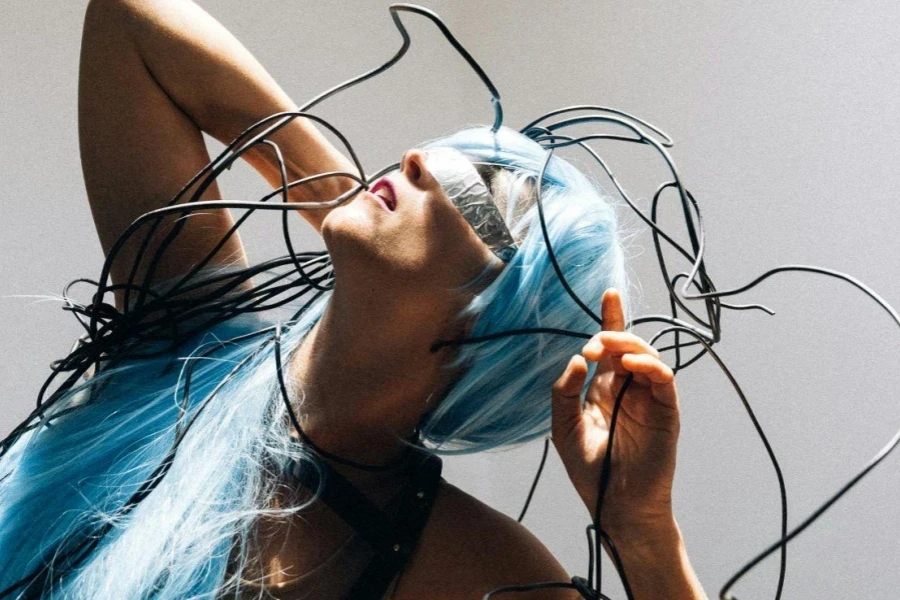 Woman Wearing a Blue Wig Staring at the Light