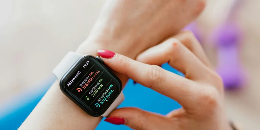 Woman checking smartwatch on hand