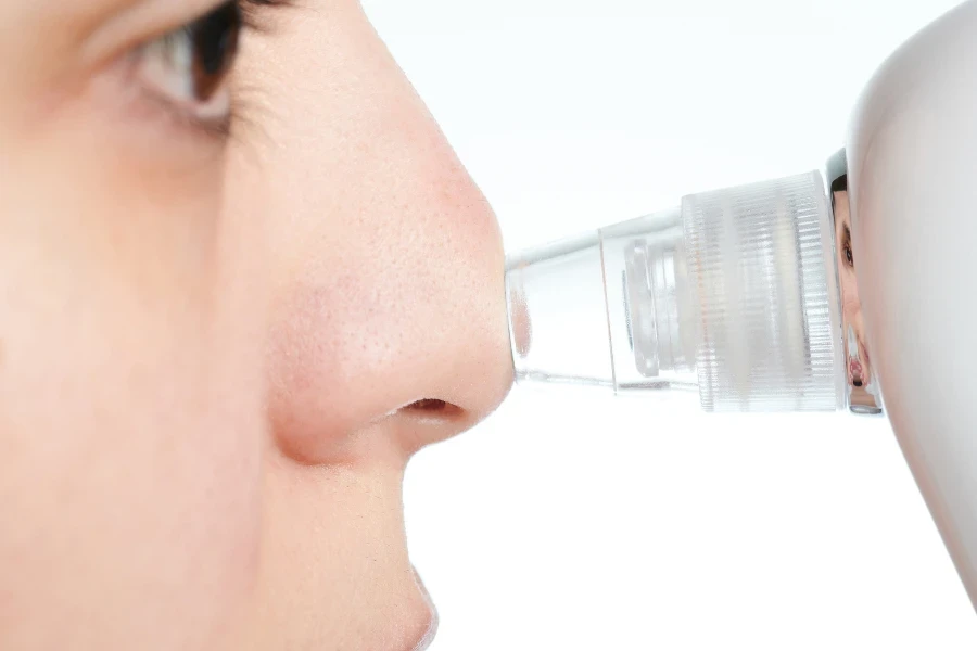 Woman clean nose from blackheads macro close up view