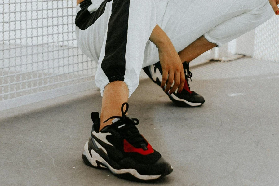 Woman crouching in a pair of high-performance shoes