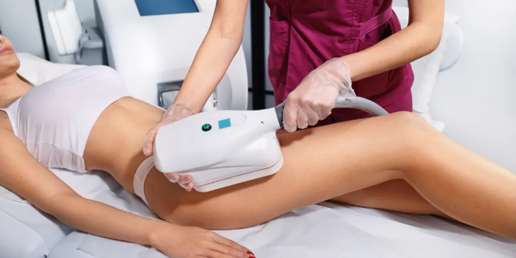 Woman getting a slimming machine treatmen