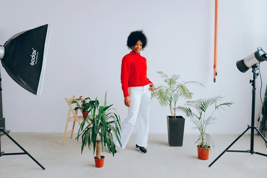 Woman having a photo session with lighting equipment on set