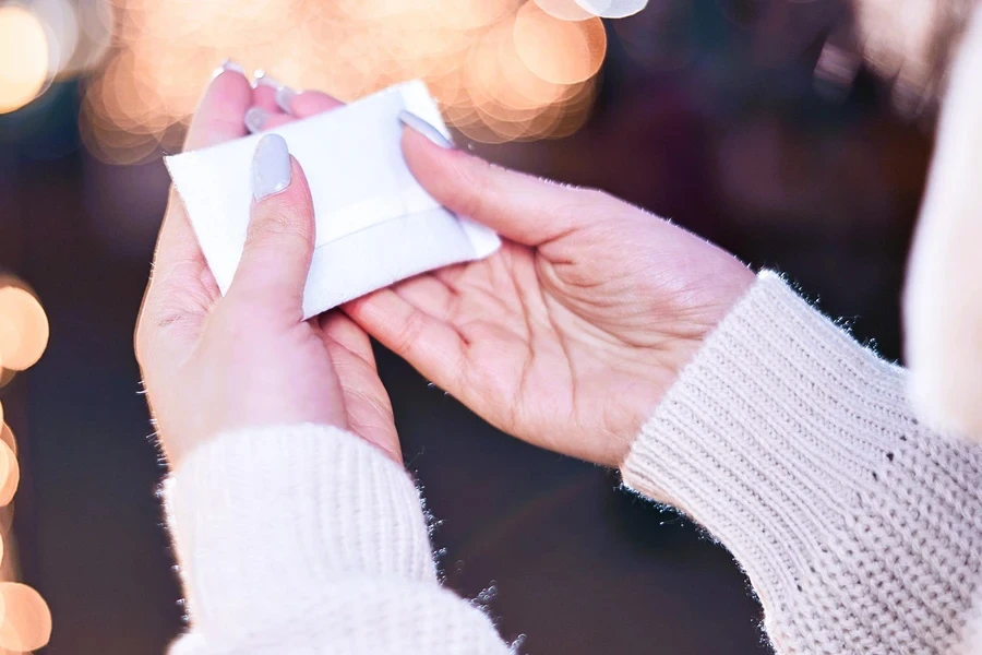 Woman holding a white hand warmer