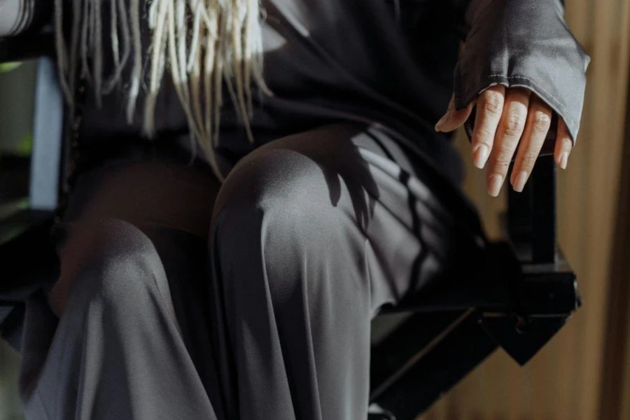 Woman in Gray Loungewear sitting on a Black Chair