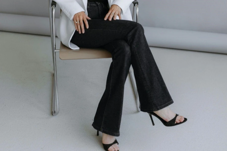 Woman in White Suit Jacket Sitting on Chair