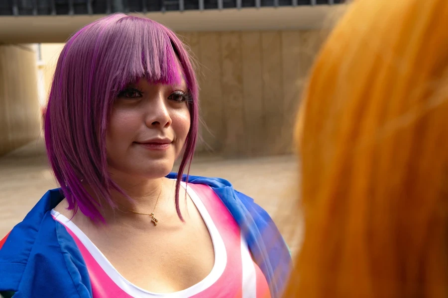 Woman in a Purple Hair Talking to a Friend with Orange Hair