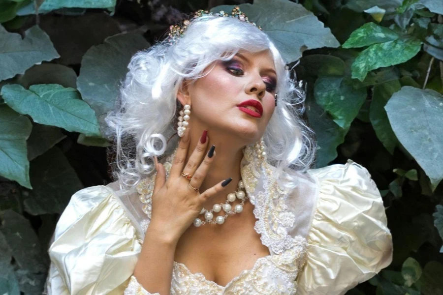 Woman in a White Gown with Pearl Necklace and Earrings