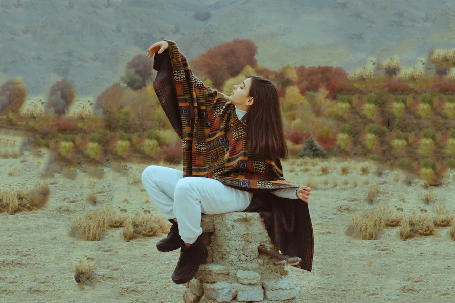 Woman in a short poncho featuring an ethnic print