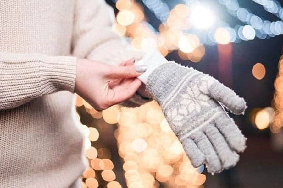 Woman inserting a hand warmer into her glove