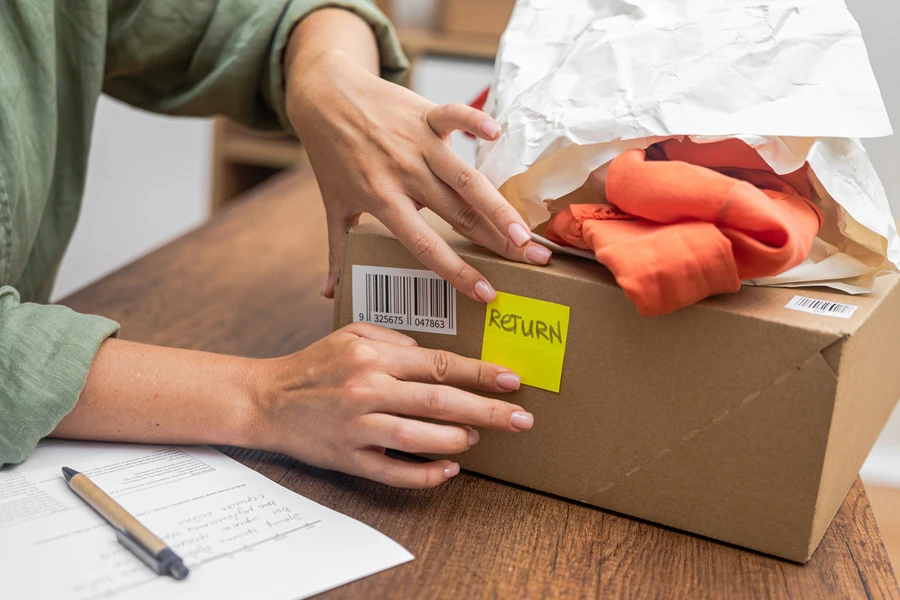 Woman preparing a package for a return and refund