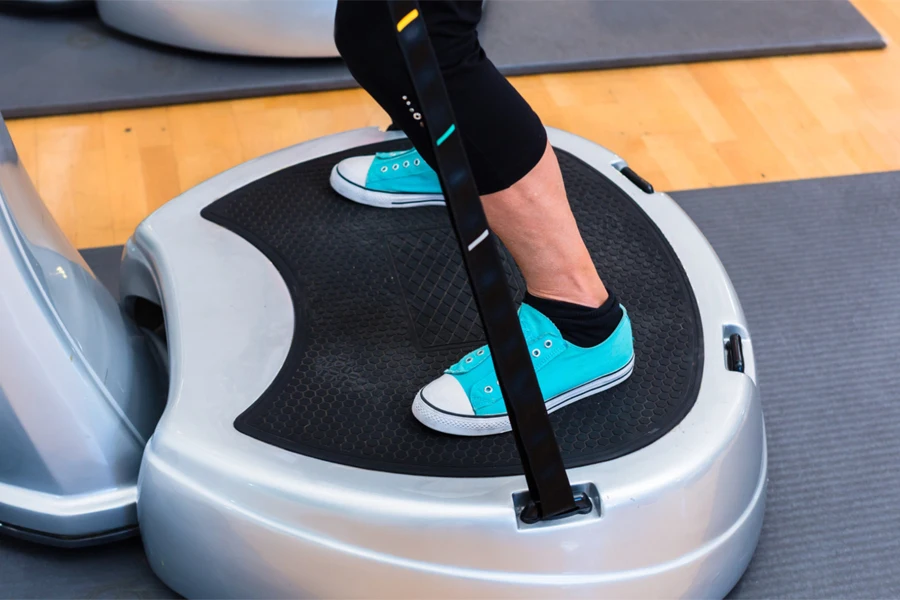 Woman resting on a large vibration plate