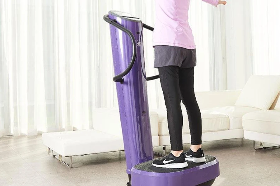 Woman standing on a purple sonic vibration machine