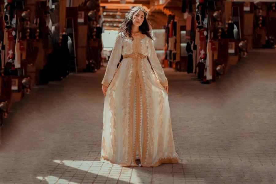 Woman wearing a white and beige formal dress kaftan