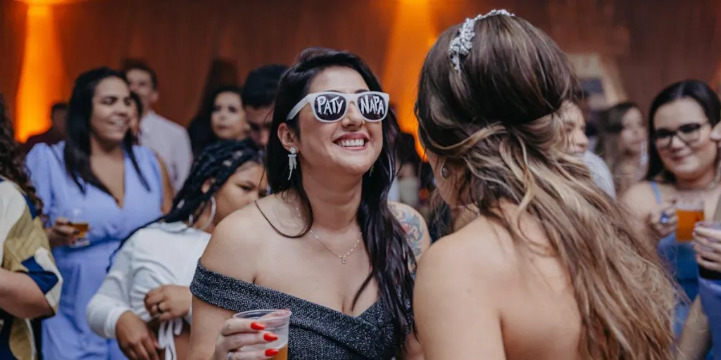 Women in wedding guest dresses having fun