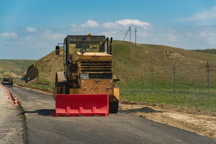 Yellow and Black Heavy Equipment on the Road