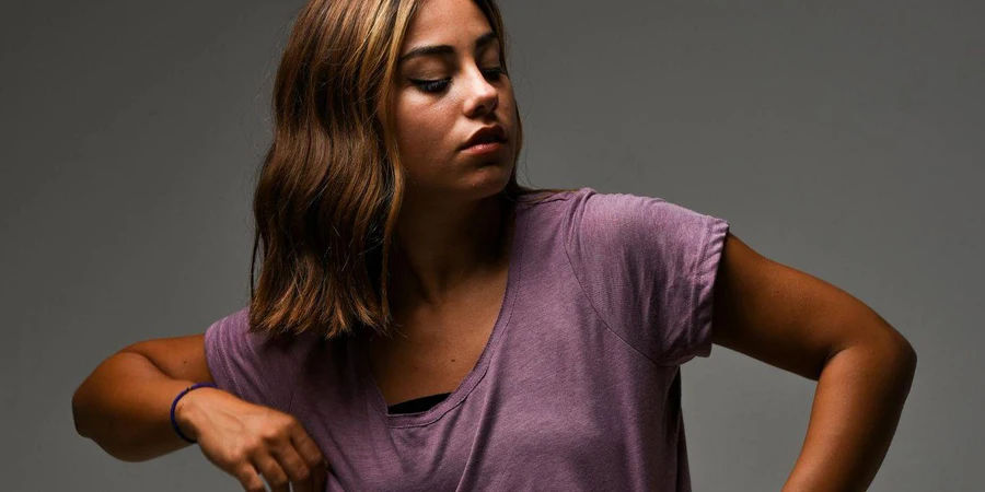 Young Woman in a T-shirt Posing in Studio