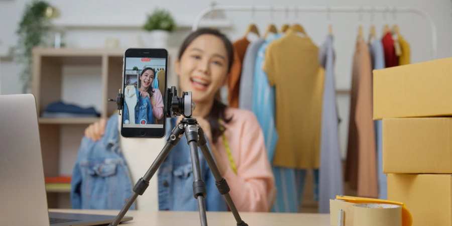 Young fashion women selling clothes by smartphone live streaming on social media platforms