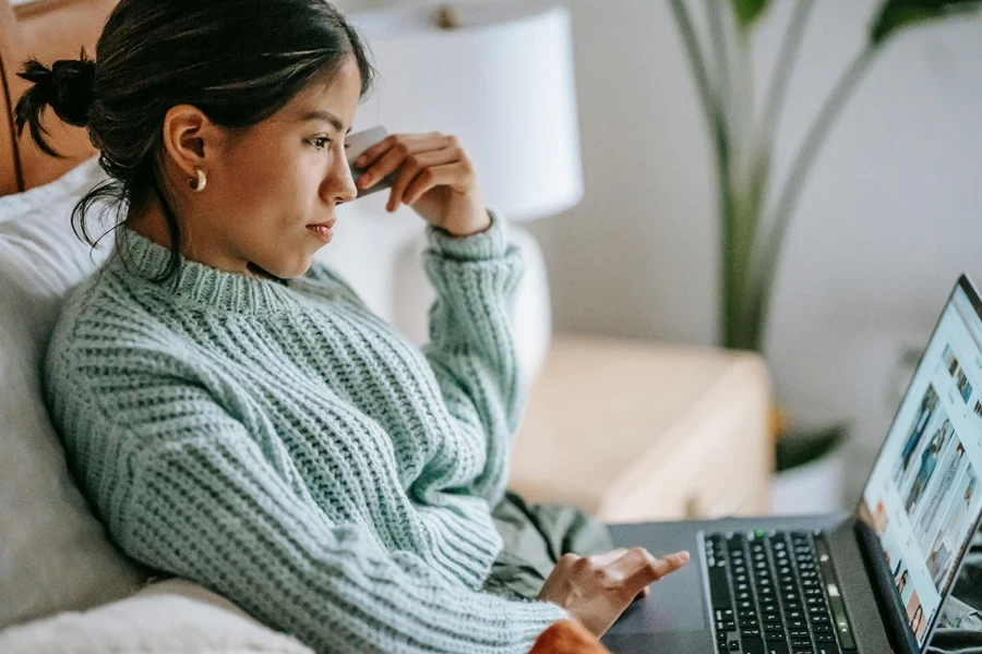 Young woman with a credit card and laptop